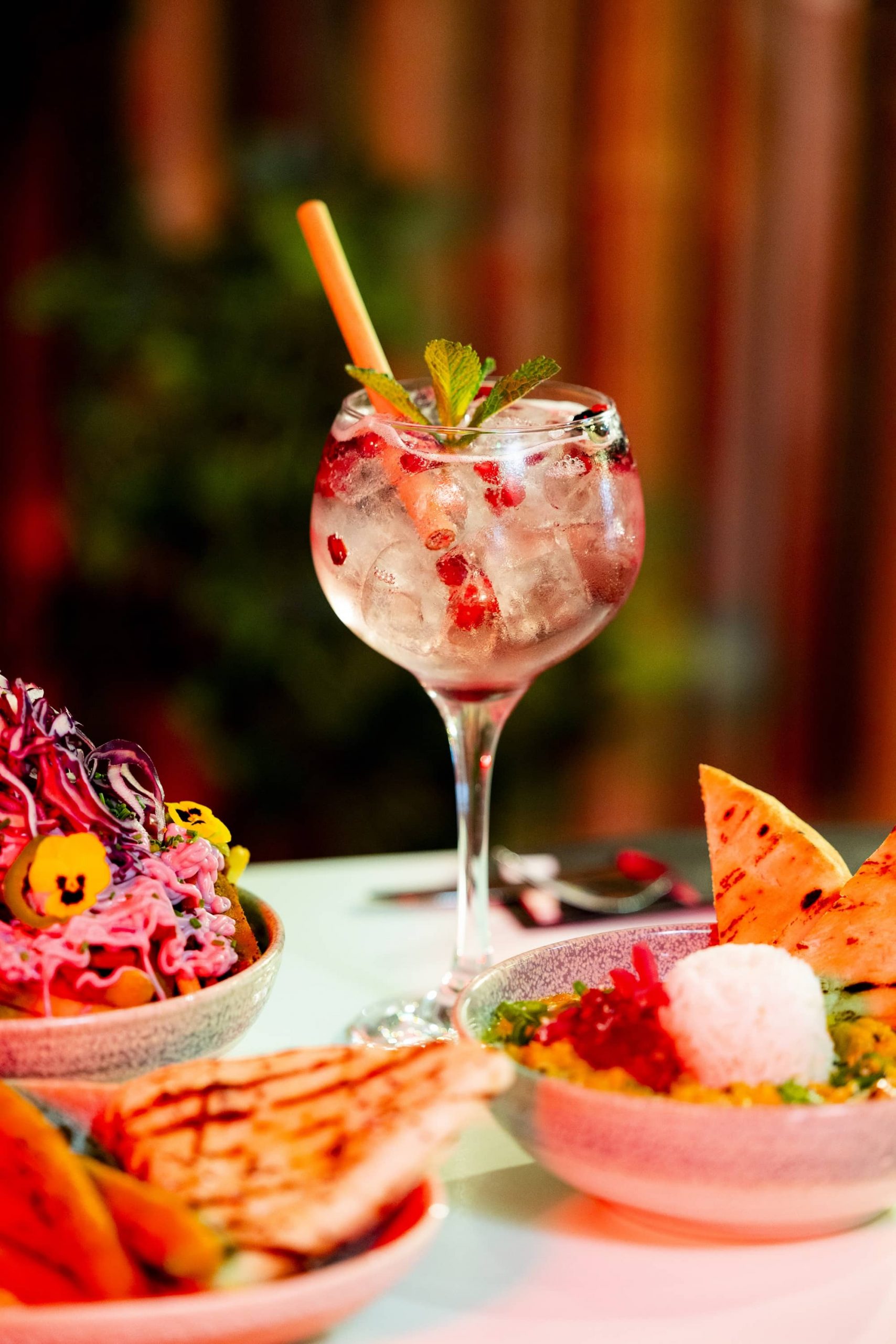 nhow_Rotterdam_Restaurant_interior_berry_cocktail_with_blurry_food_in_front